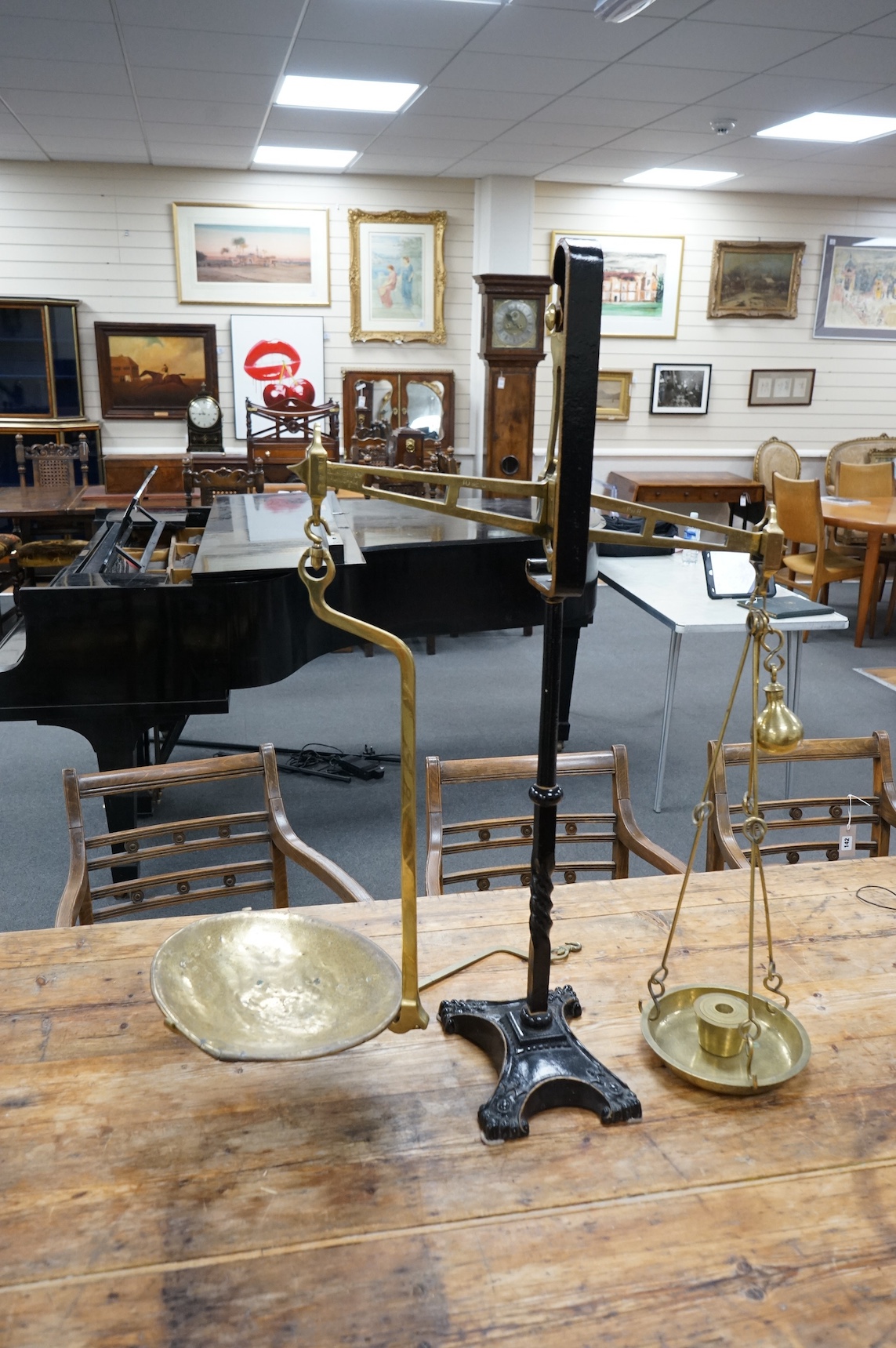 A brass Beam scale, on cast iron stand, W & T Avery, 95cm high. Condition - fair